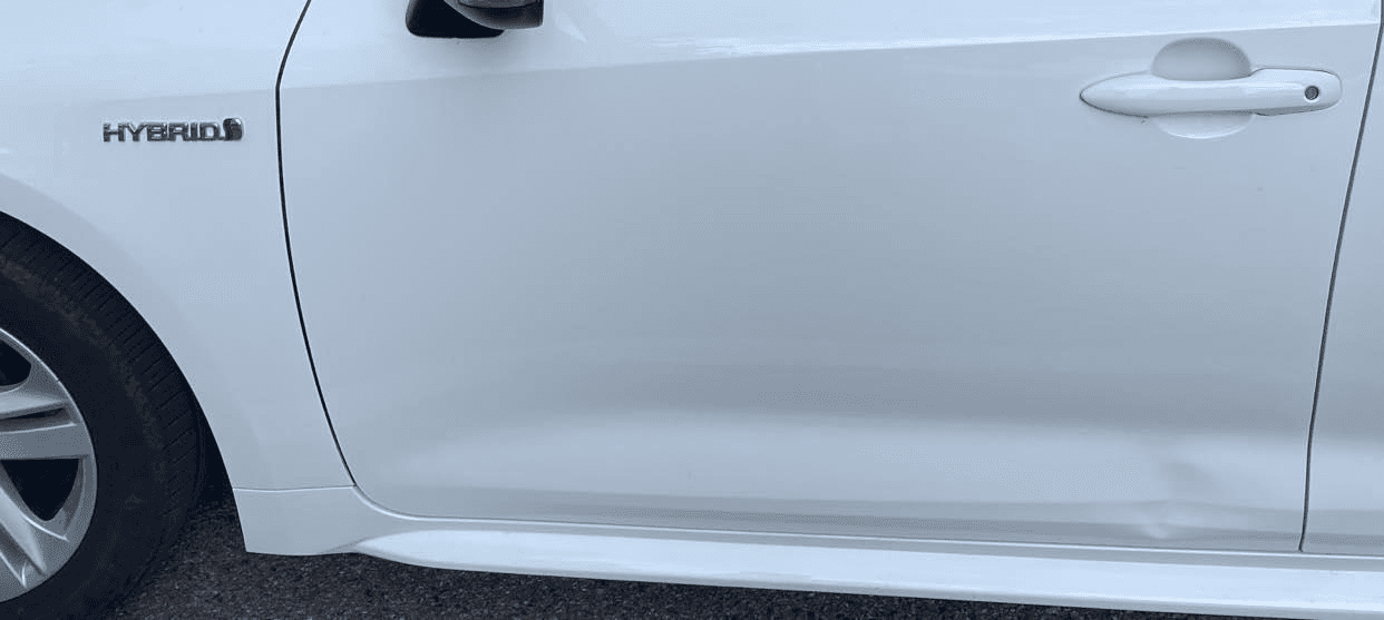 White Corolla lower door and sill dent evidence